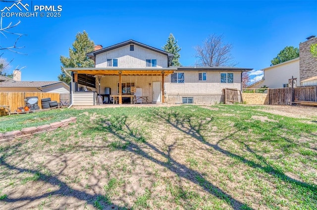 6465 Pawnee Cir, Colorado Springs, CO 80915 - back of property featuring a yard, fence, and a chimney