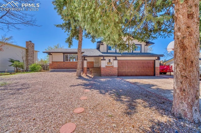 6465 Pawnee Cir, Colorado Springs, CO 80915 - ranch-style home with brick siding, driveway, and a garage