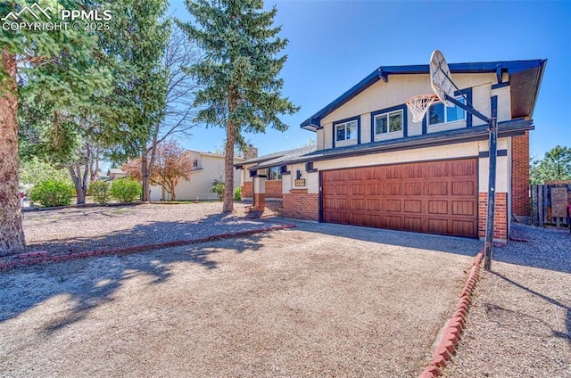 6465 Pawnee Cir, Colorado Springs, CO 80915 - view of front of property with brick siding, an attached garage, and driveway