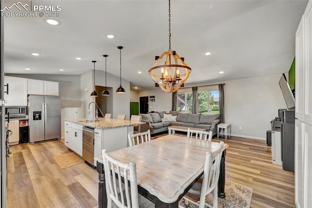 6465 Pawnee Cir, Colorado Springs, CO 80915 - dining room featuring recessed lighting, an inviting chandelier, lofted ceiling, and light wood-style floors