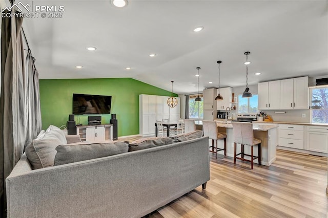 6465 Pawnee Cir, Colorado Springs, CO 80915 - living room with recessed lighting, lofted ceiling, and light wood-style floors
