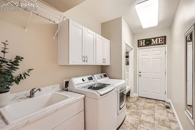 7465 Winding Oaks Dr, Colorado Springs, CO 80919 - laundry area featuring cabinet space, washer and dryer, stone finish flooring, and baseboards