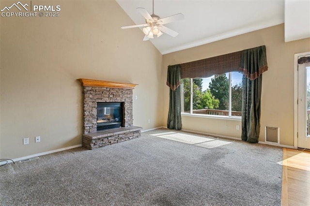 6675 Cabin Creek Dr, Colorado Springs, CO 80923 - unfurnished living room with ceiling fan, high vaulted ceiling, a stone fireplace, carpet, and baseboards