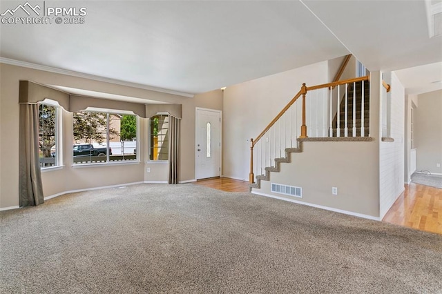 6675 Cabin Creek Dr, Colorado Springs, CO 80923 - unfurnished living room featuring carpet floors, stairs, baseboards, and ornamental molding