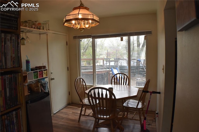 dining area featuring an inviting chandelier and wood finished floors