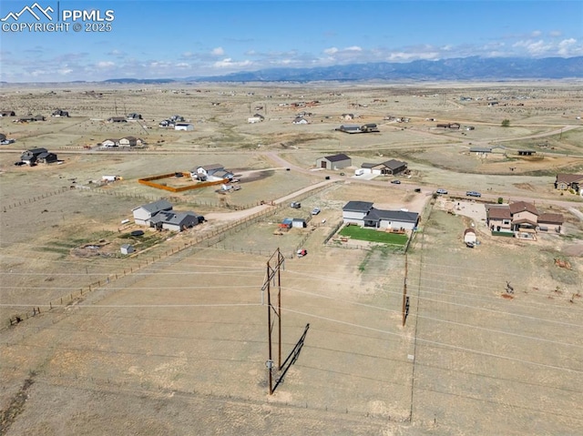 aerial view with a mountain view, view of desert, and a rural view