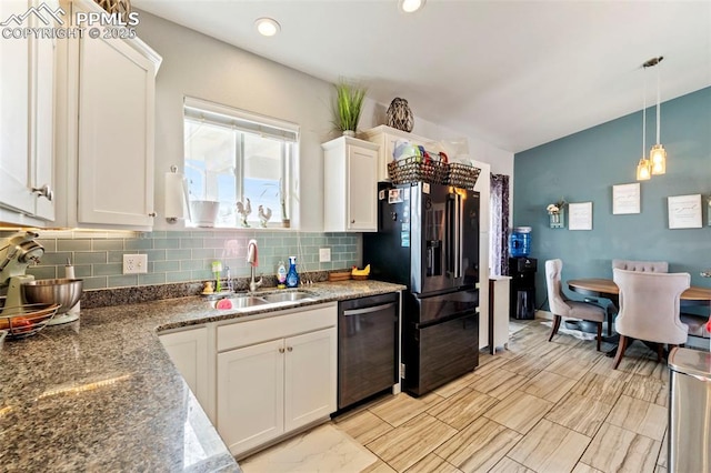kitchen featuring black fridge with ice dispenser, stainless steel dishwasher, white cabinets, tasteful backsplash, and a sink