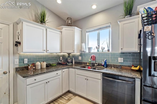 kitchen with a sink, white cabinets, and stainless steel appliances
