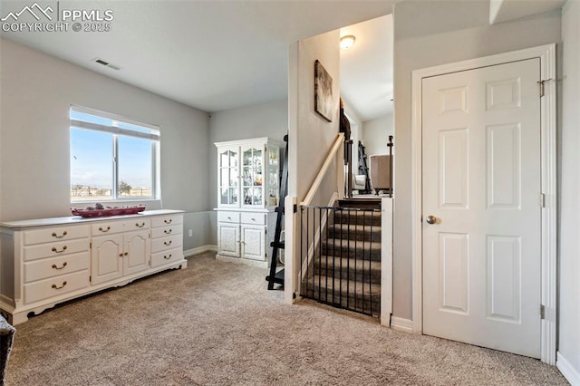 bedroom with light colored carpet, baseboards, and visible vents