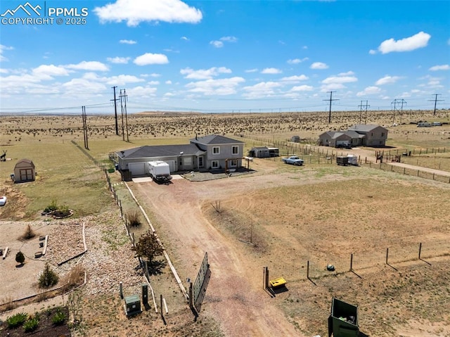 birds eye view of property with a rural view