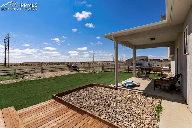 view of yard with a rural view, a fenced backyard, and a patio area