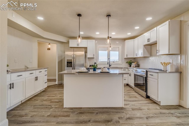 1120 Lake Woodmoor Dr, Monument, CO 80132 - kitchen featuring stainless steel appliances, white cabinets, and light wood-type flooring