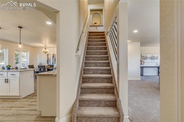 1120 Lake Woodmoor Dr, Monument, CO 80132 - staircase with a chandelier, wood finished floors, baseboards, and recessed lighting