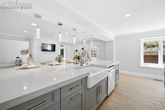 kitchen featuring dishwasher, gray cabinets, ornamental molding, and a sink