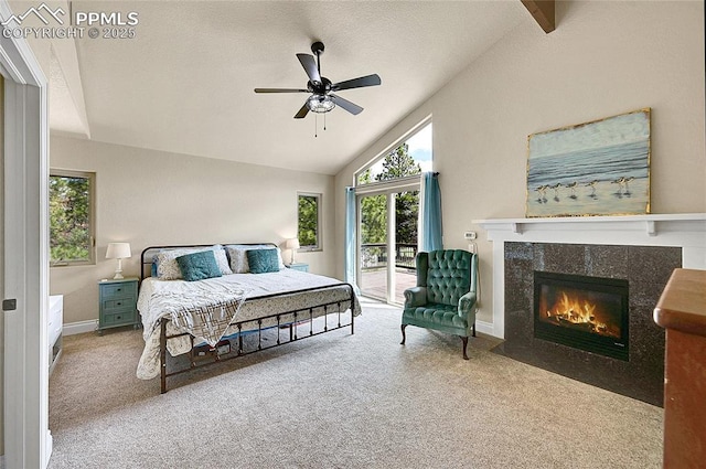17350 Goshawk Rd, Colorado Springs, CO 80908 - carpeted bedroom featuring a ceiling fan, access to exterior, a high end fireplace, vaulted ceiling, and baseboards
