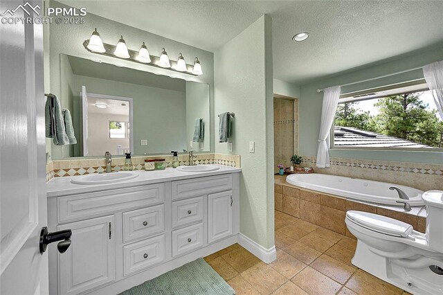 17350 Goshawk Rd, Colorado Springs, CO 80908 - full bath featuring a sink, a garden tub, and a textured ceiling
