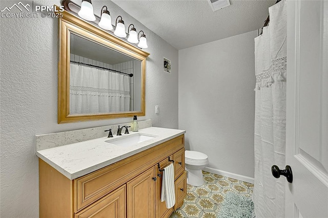 17350 Goshawk Rd, Colorado Springs, CO 80908 - full bath with visible vents, a textured wall, toilet, and vanity