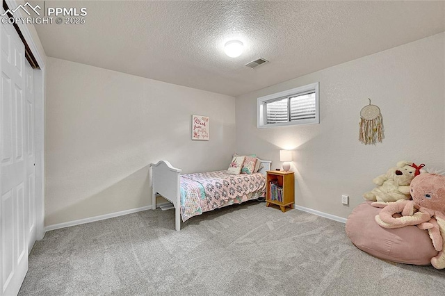17350 Goshawk Rd, Colorado Springs, CO 80908 - carpeted bedroom with baseboards, a closet, a textured ceiling, and visible vents