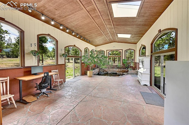 17350 Goshawk Rd, Colorado Springs, CO 80908 - exterior space with wood ceiling, plenty of natural light, rail lighting, and stone flooring