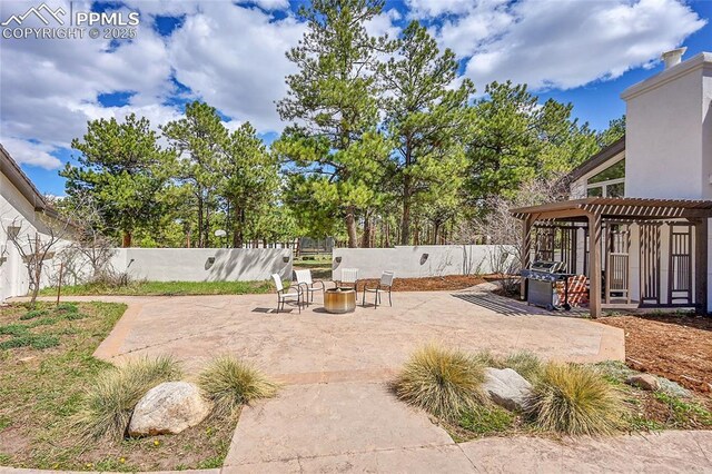 17350 Goshawk Rd, Colorado Springs, CO 80908 - view of yard featuring a patio, a fenced backyard, and an outdoor fire pit