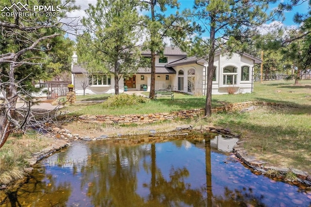 17350 Goshawk Rd, Colorado Springs, CO 80908 - rear view of house with a lawn, stucco siding, and fence