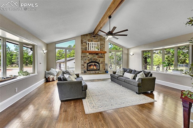 17350 Goshawk Rd, Colorado Springs, CO 80908 - living area with wood finished floors, a fireplace, baseboards, ceiling fan, and vaulted ceiling with beams