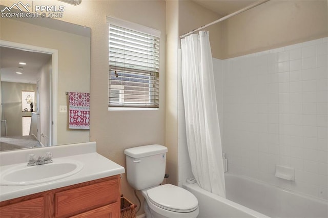bathroom featuring vanity, shower / bath combination with curtain, and toilet