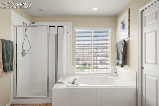 bathroom featuring a garden tub and a stall shower