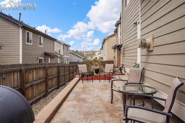 view of patio / terrace featuring a residential view and a fenced backyard