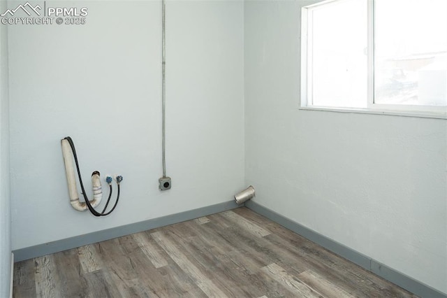 1015 5th St, Del Norte, CO 81132 - laundry room with wood finished floors, hookup for a washing machine, baseboards, and laundry area