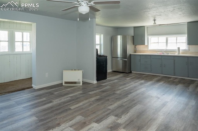 1015 5th St, Del Norte, CO 81132 - kitchen featuring tasteful backsplash, gray cabinets, ceiling fan, dark wood finished floors, and freestanding refrigerator