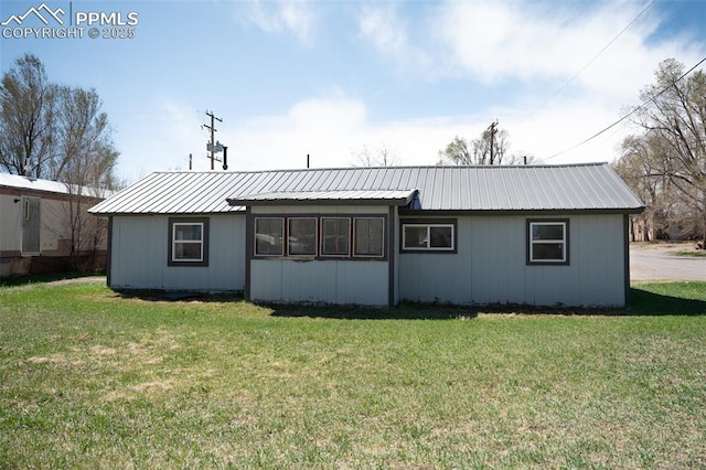 1015 5th St, Del Norte, CO 81132 - rear view of house featuring a lawn and metal roof