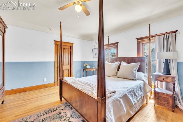 bedroom featuring ceiling fan, baseboards, and light wood finished floors