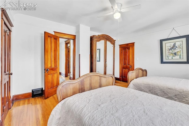 bedroom with ceiling fan, baseboards, visible vents, and light wood-type flooring