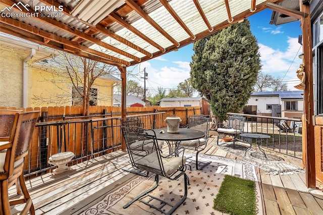 deck featuring a fenced backyard and outdoor dining space