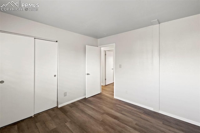 621 Rowe Ln, Colorado Springs, CO 80911 - unfurnished bedroom featuring a closet, baseboards, and wood finished floors