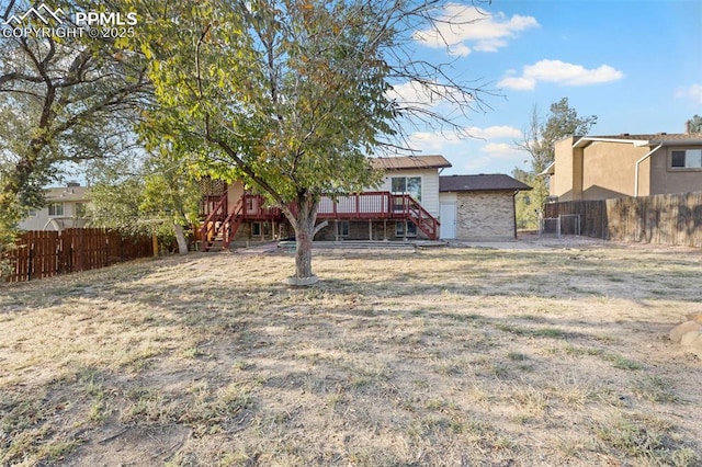 621 Rowe Ln, Colorado Springs, CO 80911 - view of yard with a deck, fence, and stairs