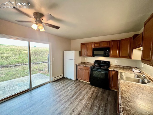 1154 Darby St, Colorado Springs, CO 80907 - kitchen with black appliances, a baseboard heating unit, a sink, ceiling fan, and dark wood finished floors