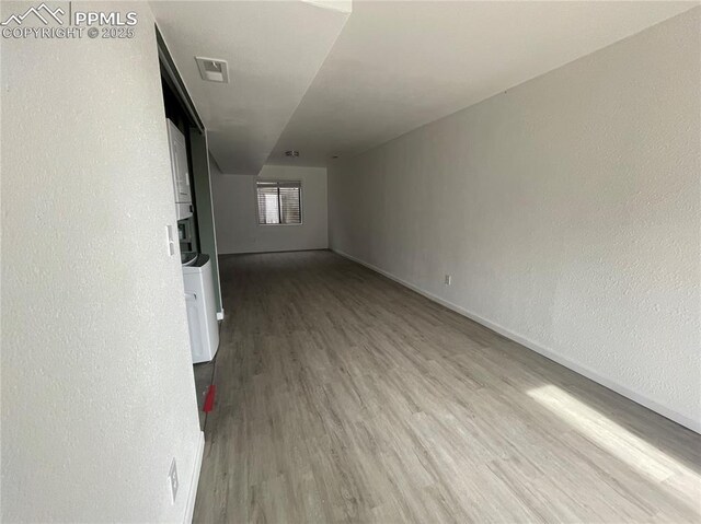 1426 Territory Trl, Colorado Springs, CO 80919 - unfurnished living room featuring wood finished floors, baseboards, and visible vents