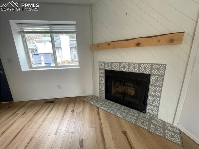1426 Territory Trl, Colorado Springs, CO 80919 - details with visible vents, baseboards, wood finished floors, and a fireplace