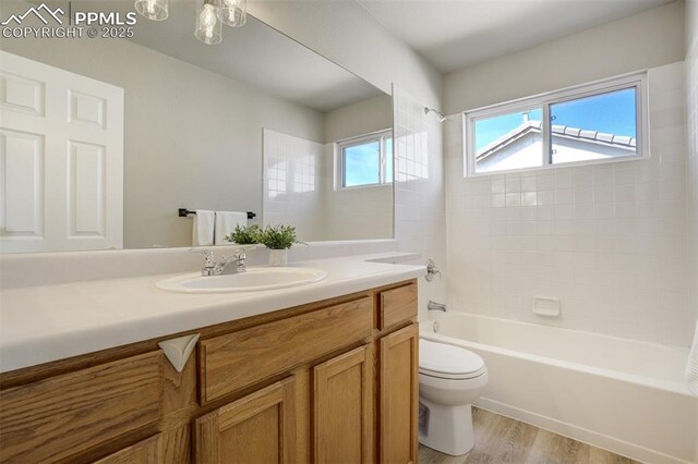 5717 Stable Ct, Colorado Springs, CO 80920 - full bath with toilet, vanity, shower / washtub combination, and wood finished floors