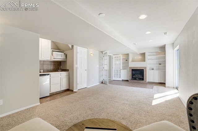 5717 Stable Ct, Colorado Springs, CO 80920 - living room with light carpet, baseboards, a glass covered fireplace, and recessed lighting