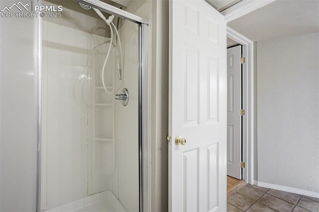 5717 Stable Ct, Colorado Springs, CO 80920 - bathroom featuring a shower stall, tile patterned flooring, and baseboards