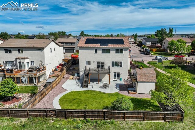 5717 Stable Ct, Colorado Springs, CO 80920 - back of house with a patio area, a residential view, stairs, and roof mounted solar panels
