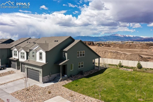 8162 Grey Bark Way, Colorado Springs, CO 80908 - view of front of house featuring an attached garage, driveway, a mountain view, and roof with shingles