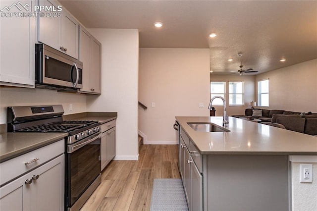 8162 Grey Bark Way, Colorado Springs, CO 80908 - kitchen featuring stainless steel appliances, a sink, gray cabinetry, light wood finished floors, and recessed lighting