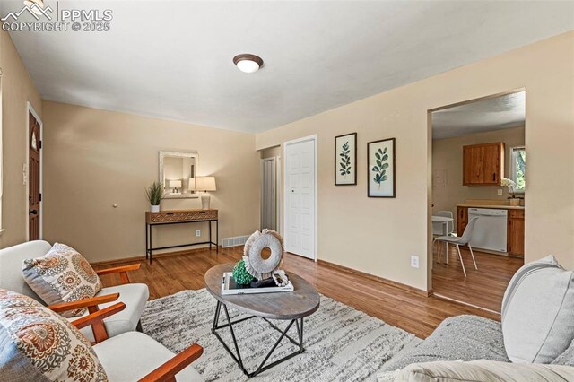 930 Bowser Dr, Colorado Springs, CO 80909 - living area with wood finished floors and baseboards