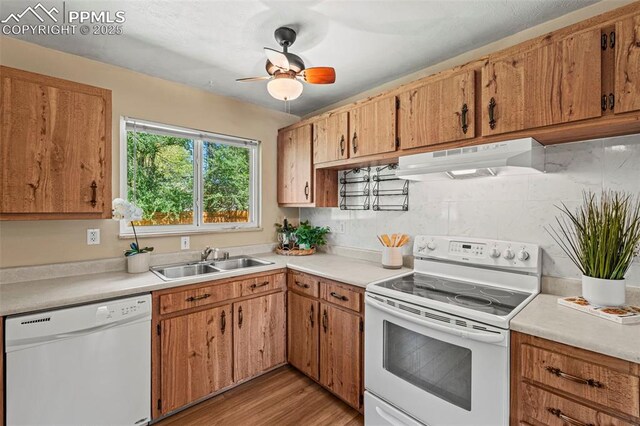 930 Bowser Dr, Colorado Springs, CO 80909 - kitchen featuring white appliances, under cabinet range hood, a sink, light countertops, and a ceiling fan