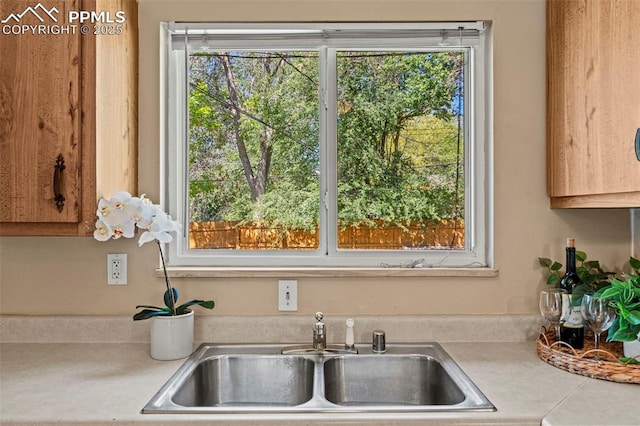 930 Bowser Dr, Colorado Springs, CO 80909 - kitchen featuring a sink, light countertops, and healthy amount of natural light