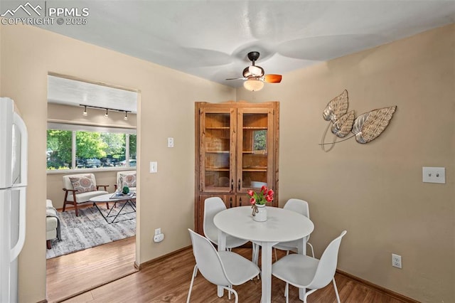 930 Bowser Dr, Colorado Springs, CO 80909 - dining area featuring wood finished floors, ceiling fan, and baseboards